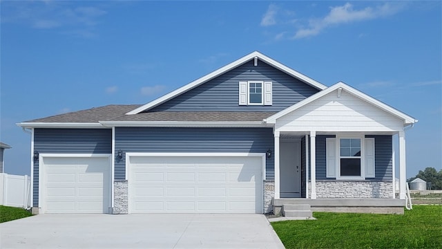 view of front of home with a garage and a front lawn