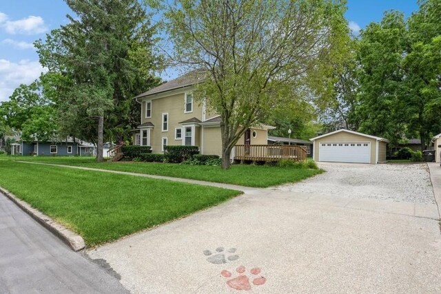 view of front of property with an outbuilding, a deck, and a front yard