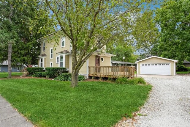 view of front of house featuring a garage, a deck, and a front yard