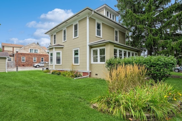 rear view of house featuring a lawn