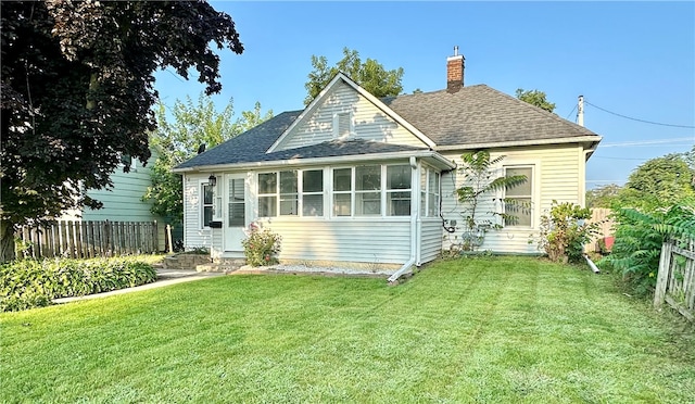 rear view of house with a yard