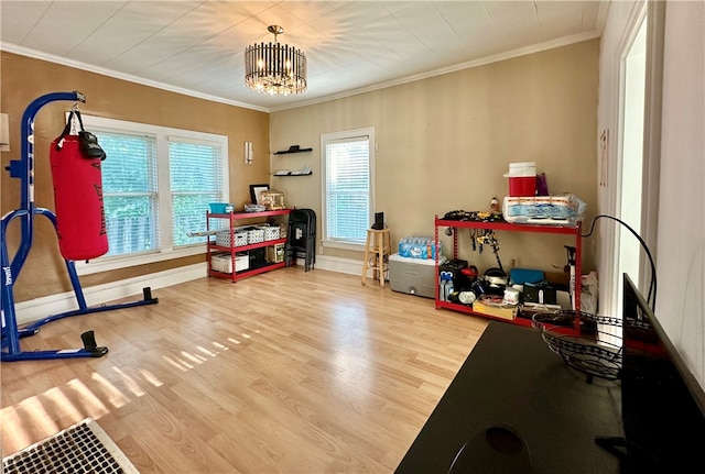 interior space featuring crown molding, an inviting chandelier, and light wood-type flooring