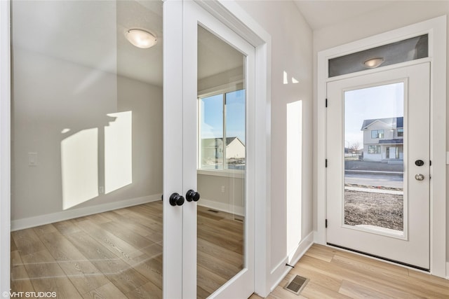 doorway to outside with light hardwood / wood-style flooring and french doors