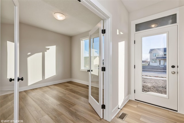 doorway to outside featuring french doors and light hardwood / wood-style flooring