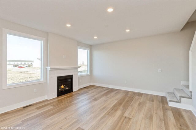 unfurnished living room featuring light hardwood / wood-style flooring