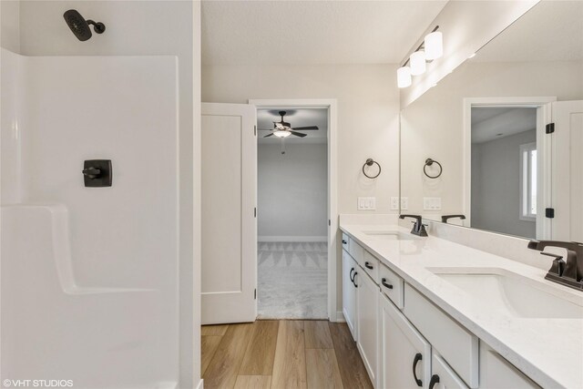 bathroom featuring hardwood / wood-style floors, vanity, and ceiling fan