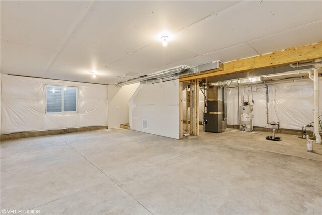 basement featuring gas water heater and heating unit