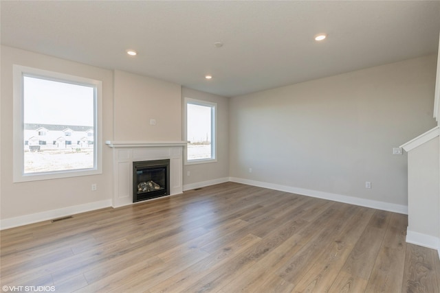 unfurnished living room featuring light wood-type flooring