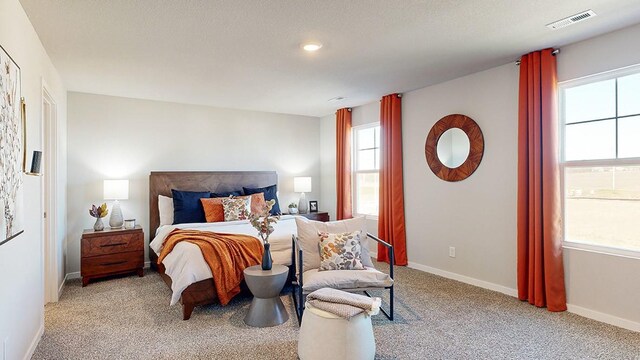 carpeted bedroom featuring a textured ceiling