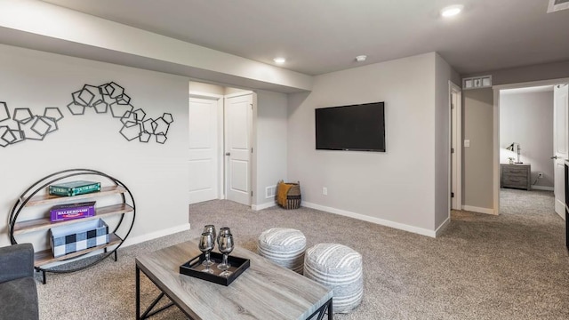 living area featuring carpet, baseboards, and recessed lighting