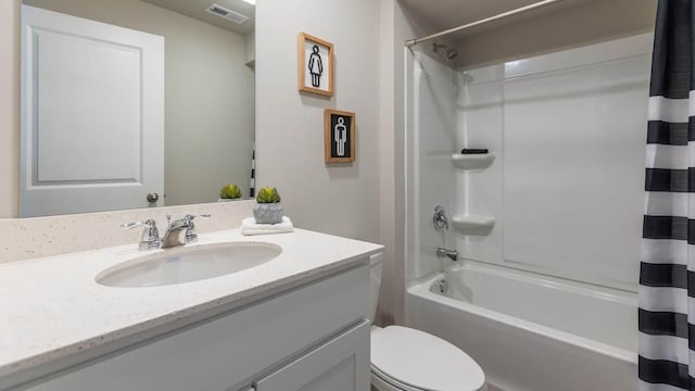 full bathroom featuring toilet, vanity, visible vents, and shower / tub combo with curtain