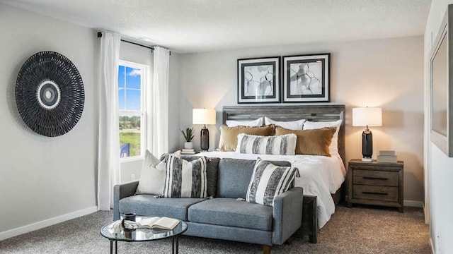 carpeted bedroom with a textured ceiling and baseboards