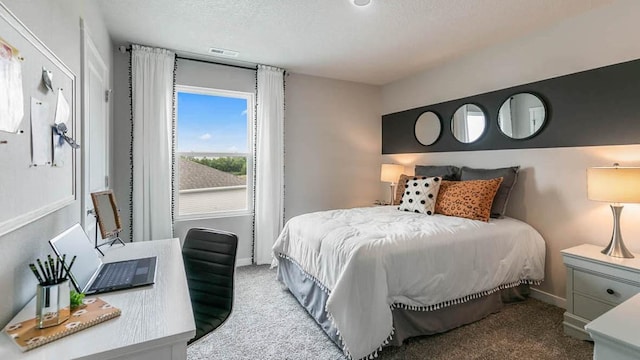 bedroom featuring baseboards, a textured ceiling, visible vents, and carpet flooring