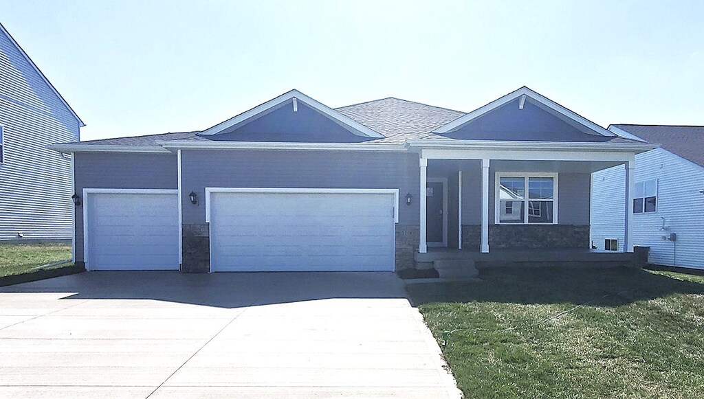 1044 Westridge St SW, Bondurant, IA 50035 - single story home with an attached garage, concrete driveway, and a front lawn