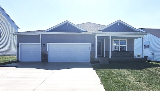 single story home with an attached garage, concrete driveway, and a front lawn
