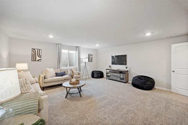 carpeted living area featuring baseboards, visible vents, and recessed lighting