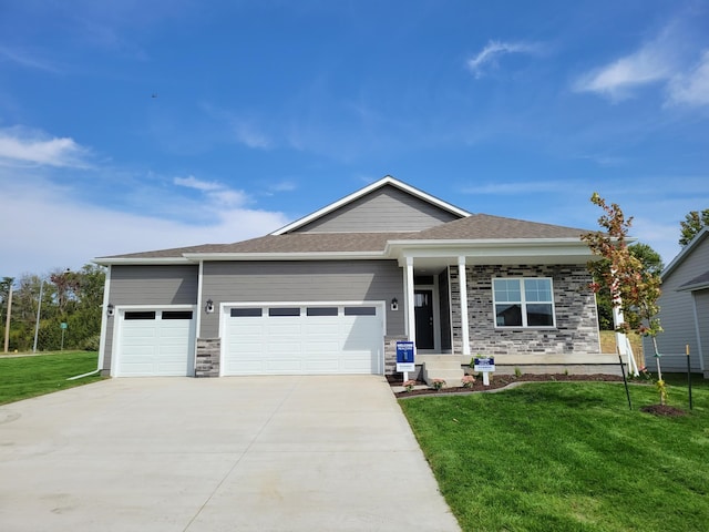 view of front of house featuring a garage and a front yard