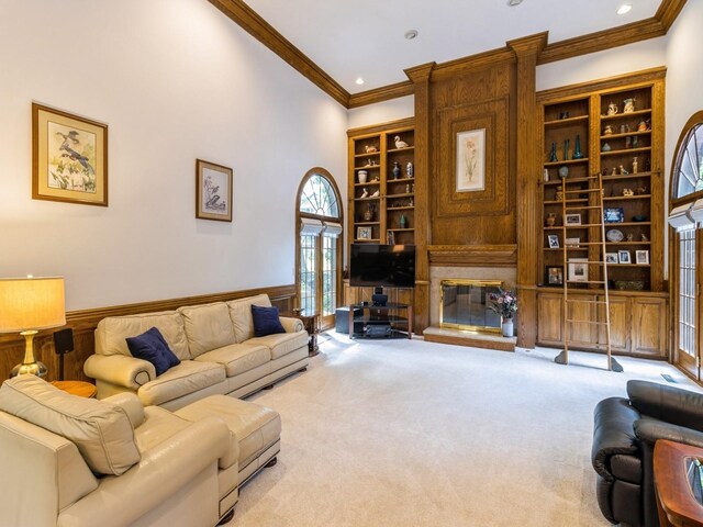 carpeted living room with a towering ceiling and ornamental molding