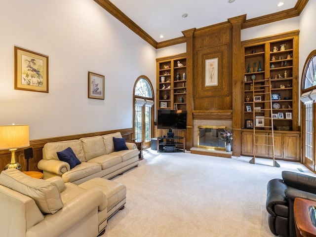 carpeted living room with a fireplace, crown molding, and built in features