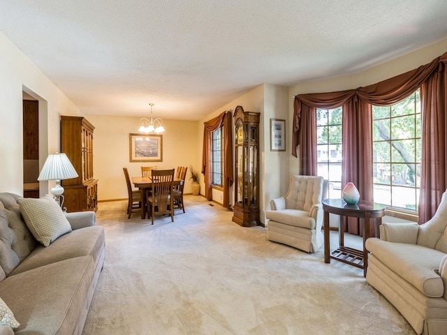 carpeted living room with a textured ceiling and a chandelier