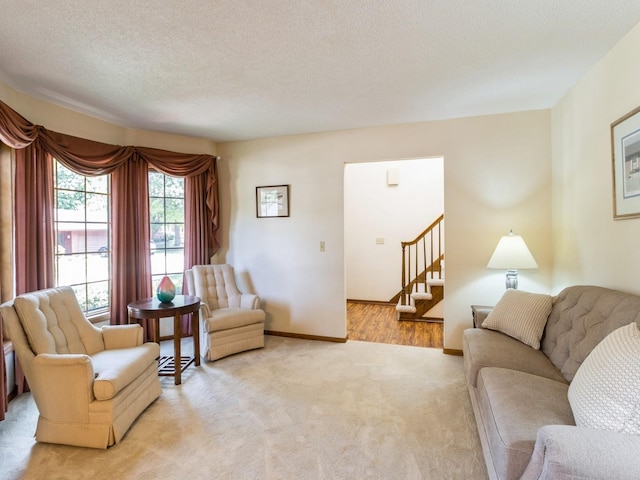 living room with light carpet and a textured ceiling