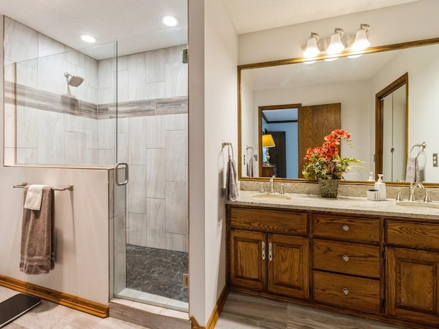 bathroom featuring vanity and an enclosed shower