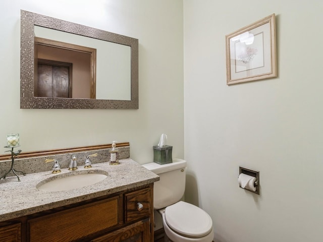 bathroom with toilet and vanity