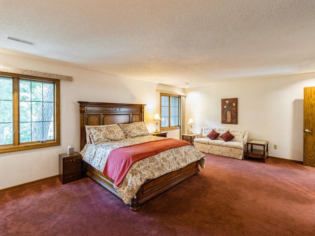 carpeted bedroom with a textured ceiling