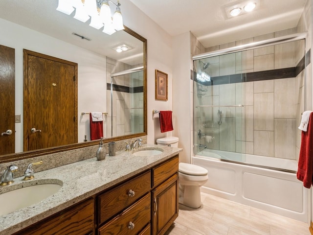 full bathroom with toilet, vanity, and enclosed tub / shower combo