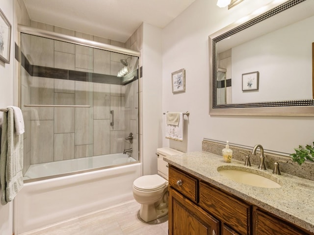 full bathroom with shower / bath combination with glass door, vanity, and toilet