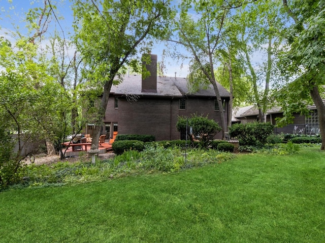 rear view of property with a yard