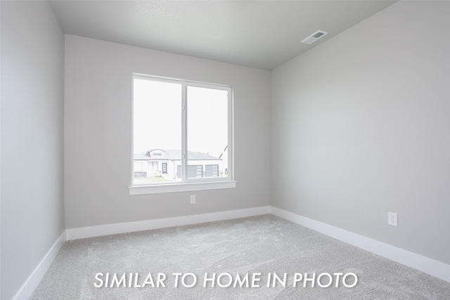 spare room with visible vents, carpet flooring, and baseboards