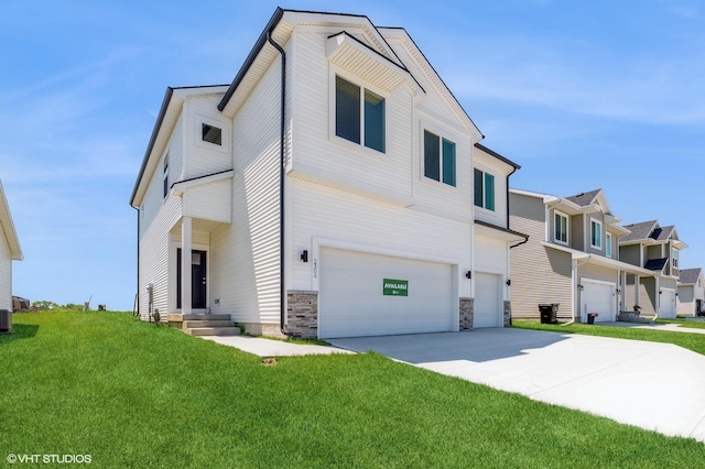2304 Chan Dr, Adel, IA 50003 - contemporary home with a garage, a front yard, driveway, and stone siding