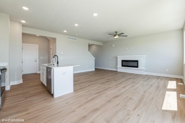 2304 Chan Dr, Adel, IA 50003 - kitchen featuring a ceiling fan, a center island with sink, recessed lighting, light wood finished floors, and appliances with stainless steel finishes