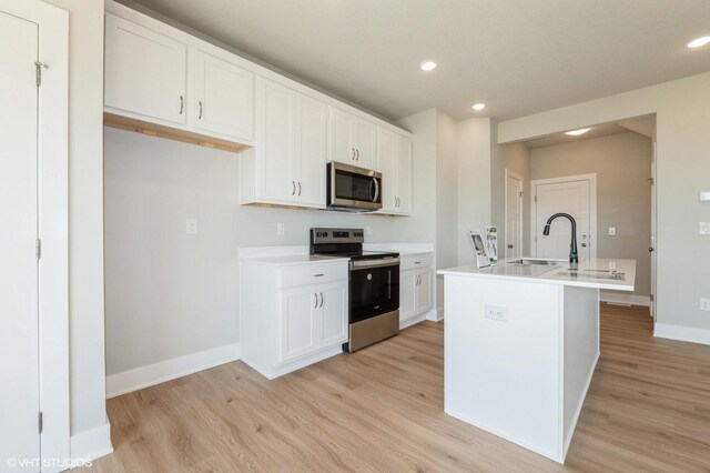 2304 Chan Dr, Adel, IA 50003 - kitchen featuring stainless steel appliances, light wood-style flooring, white cabinetry, light countertops, and recessed lighting