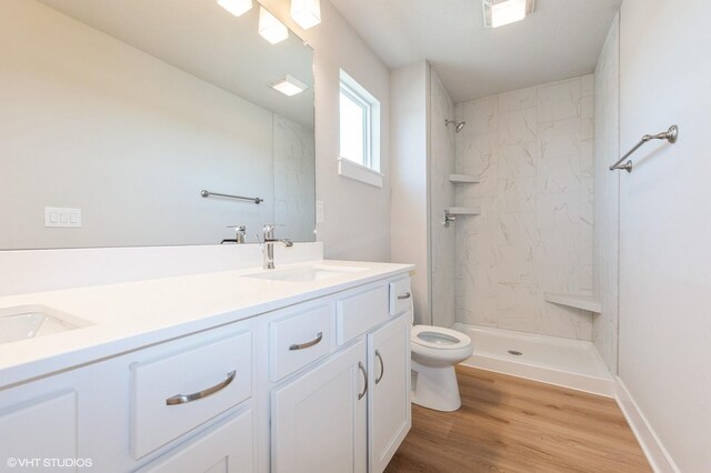 2304 Chan Dr, Adel, IA 50003 - full bathroom with double vanity, a marble finish shower, and wood finished floors