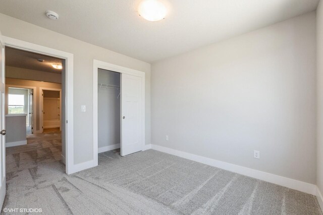 2304 Chan Dr, Adel, IA 50003 - unfurnished bedroom featuring carpet flooring and a closet