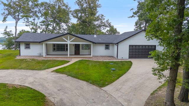 ranch-style house with a garage and a front lawn