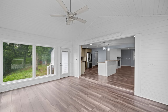 unfurnished living room featuring high vaulted ceiling, a ceiling fan, and wood finished floors