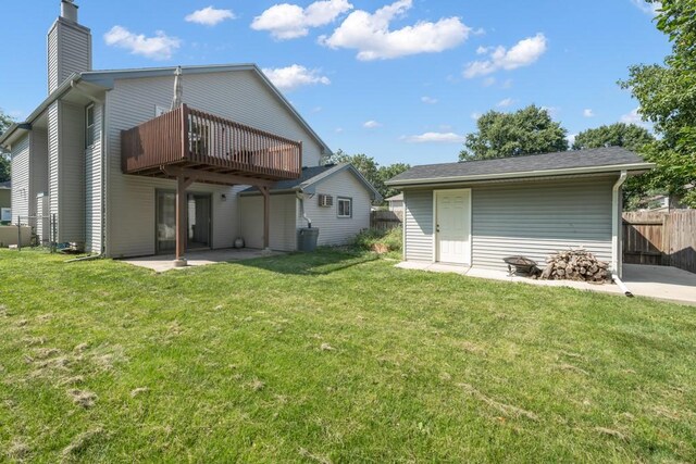 rear view of house with a patio and a lawn