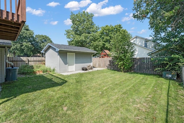 view of yard with a fenced backyard and an outbuilding