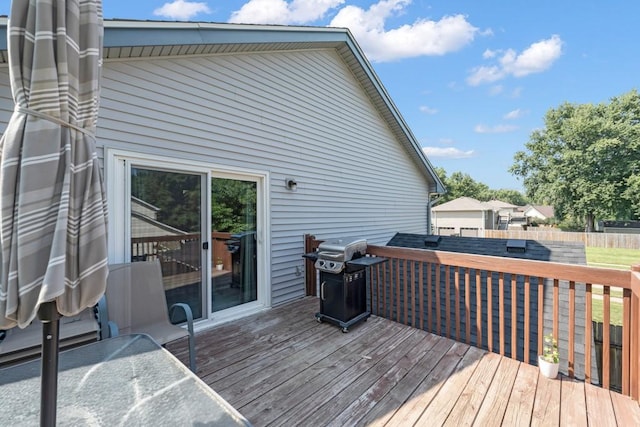 wooden deck with grilling area and fence