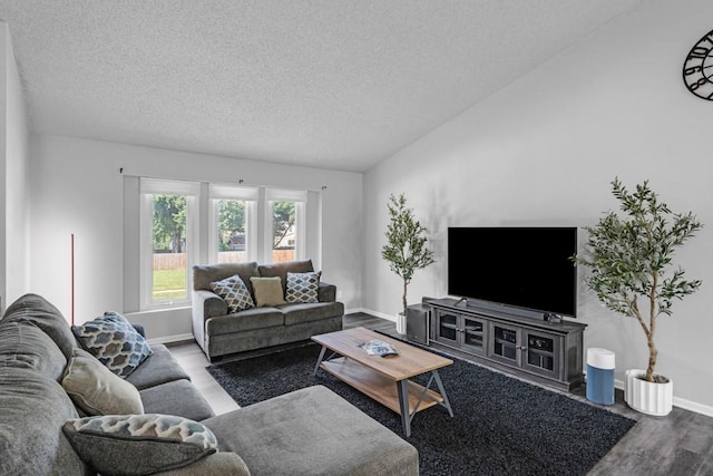 living room featuring lofted ceiling, a textured ceiling, wood finished floors, and baseboards