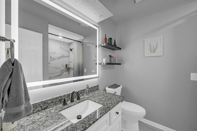 full bathroom with vanity, a marble finish shower, toilet, and baseboards