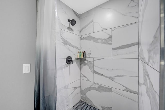 interior details with a tile shower