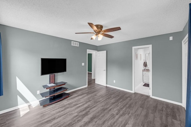 unfurnished living room with visible vents, a ceiling fan, a textured ceiling, wood finished floors, and baseboards