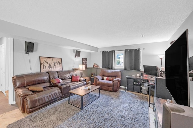 living area featuring a textured ceiling and tile patterned floors