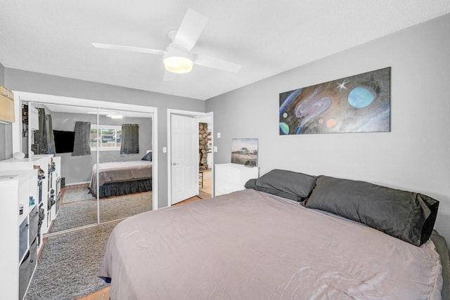 bedroom with light carpet, a ceiling fan, and a closet