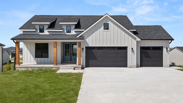 modern farmhouse style home with a shingled roof, a porch, board and batten siding, and a front yard