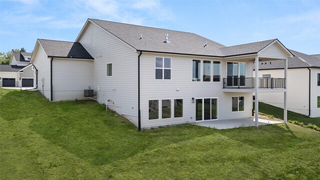 back of house featuring a yard, a balcony, a patio, and central AC